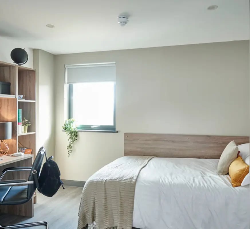 Bed desk bookshelf with globe and backpack bedroom at Trinity View Coventry in Coventry Student Accommodation